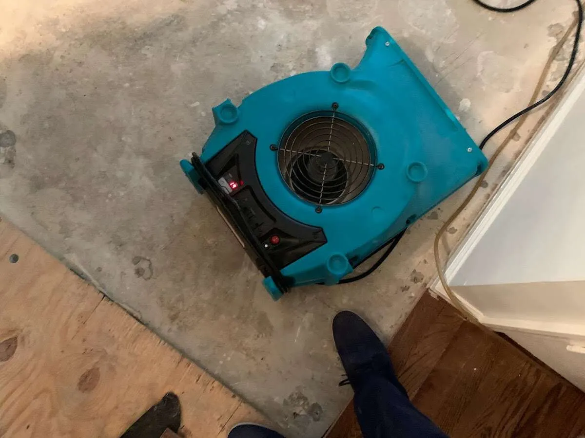 Air mover drying subfloor during Leak Detection & Repair in Kronenwetter
